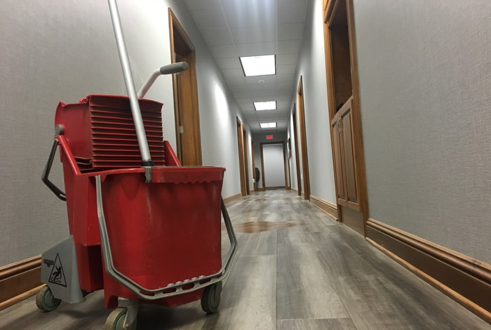 Cleaning floors in a modern office.